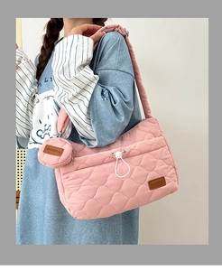 Pink quilted shoulder bag detail with matching round coin purse and drawstring design