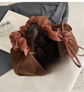 Detailed interior of plush teddy bag featuring a large main compartment and zipper pocket