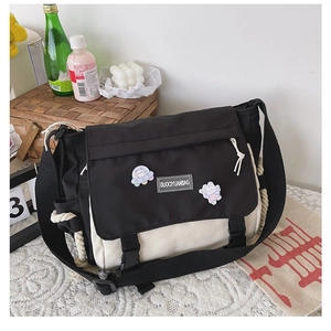 Detail of canvas messenger bag with contrast stitching and adjustable wide shoulder strap