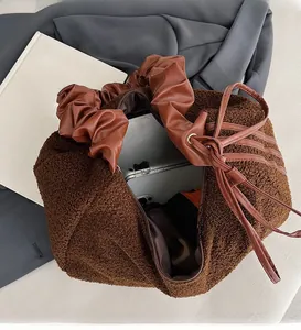 Interior detail of plush brown dumpling bag showing large storage capacity for tablets