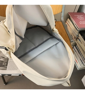 Interior view of minimalist backpack showing a padded laptop compartment and spacious storage