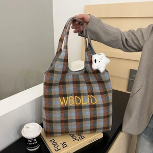 Close-up of retro plaid tote bag with letter embroidery and star plush pendant