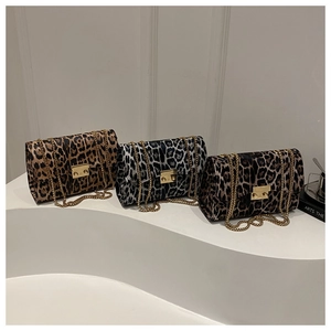 Detailed comparison of three leopard print crossbody bags with golden chain straps and locks