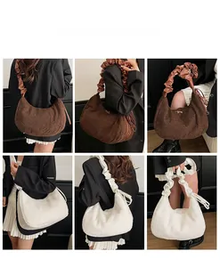 Detail showing plush dumpling bag with ruffled cloud straps in brown and cream beige