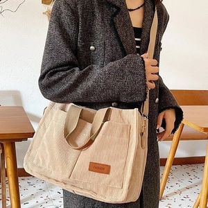 Large beige corduroy tote bag with fashion label and adjustable shoulder strap for women
