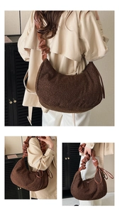 Detail of dark brown faux fur hobo bag with unique leather pleated shoulder strap