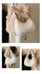Detail view of a white plush crescent bag featuring pleated strap and fuzzy texture