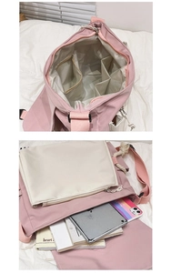 Detail view of pink canvas messenger bag showing large capacity and internal pockets