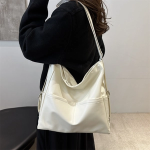 Minimalist large white leather tote backpack for women shown on model for commuting style