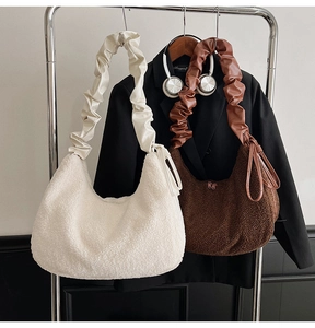 Detail of plush faux fur hobo bags in off-white and brown with scrunched straps