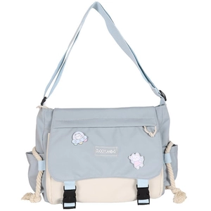 Minimalist dark aesthetic messenger bag in blue and beige with cartoon pins