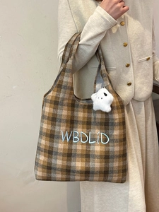 Brown plaid wool tote bag with blue letter embroidery and a white fuzzy star charm detail
