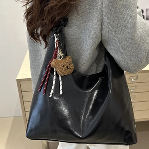 Vintage black leather tote bag for women with a cute teddy bear charm and large capacity