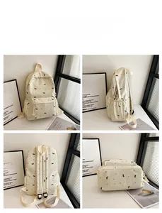 Vue détaillée sous quatre angles d'un sac à dos crème avec motifs chiens et fleurs