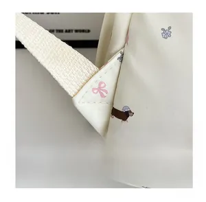 Gros plan détaillé des coutures triangulaires renforcées du sac à dos fleuri teckel