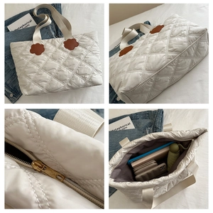 Detailed views of white quilted tote bag with brown flower patches and large interior