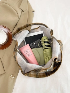 Spacious interior of plaid tote bag showing capacity for tablet, phone, and daily essentials