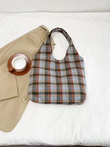 Detailed flat lay of plaid wool tote bag with classic blue and brown vintage patterns