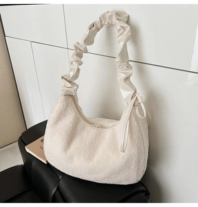 Detail of plush off-white hobo bag with satin gathered cloud handle and zipper closure