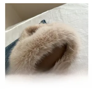 Macro shot of fluffy beige faux fur texture on a soft winter tote bag handle