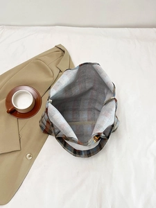 Internal view of a spacious plaid tote bag featuring blue and orange checkered fabric