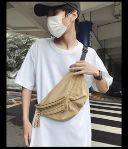 Khaki nylon crossbody chest bag for men featuring dual front zippers and woven rope detail