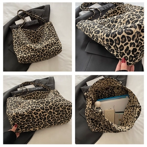 Detailed view of leopard print tote bag interior showing large capacity for books and essentials