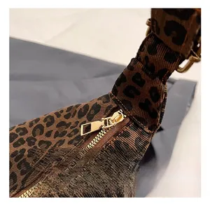 Detail of high-quality golden metal zipper on a stylish leopard print tote bag