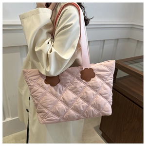 Quilted pink tote bag with brown flower leather patches and chic woven handles