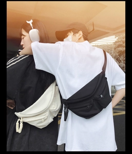 Close-up of black and white crescent crossbody chest bags with woven zipper detail