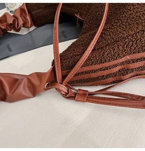Close-up of brown faux fur texture and gathered PU leather shoulder strap detail