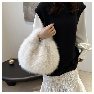 Close-up detail showing the soft white faux fur texture of this fluffy handheld winter bag