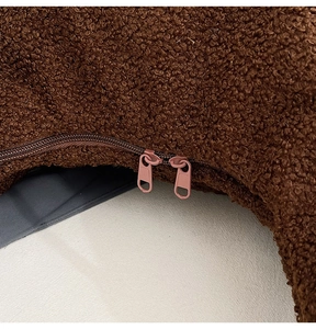 Detail view of the brown teddy fleece shoulder bag with dual matte metal zippers