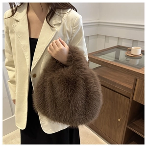 Close-up of a dark brown faux fur handbag with a soft plush texture in a lifestyle setting