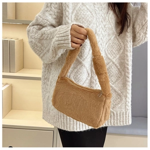 Detail of plush brown faux fur shoulder bag with soft texture for winter style