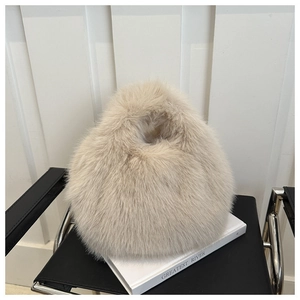 Detailed macro view of soft light brown faux fur texture on a spherical handbag