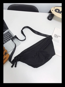 Detailed top view of black nylon crossbody bag with multi-pocket zipper and adjustable strap