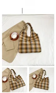 Detail of vintage brown plaid tote bag featuring white WBDLID letter embroidery