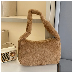 Detail shot of brown plush hobo bag with soft faux fur texture and metal zipper