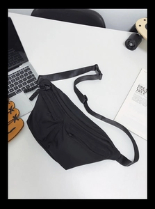 Detailed top view of black multi-pocket crossbody bag with adjustable nylon straps
