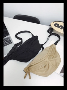 Macro view showing multi-zipper compartments and woven pullers on durable nylon chest bag