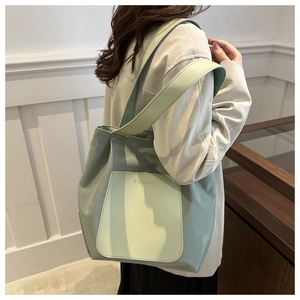 Detail view of the mint green tote bag showing the side structure and double straps