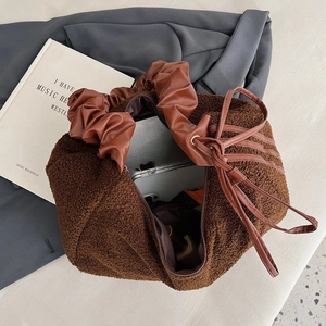 Brown teddy fleece tote bag with ruched handle showing large capacity for laptops