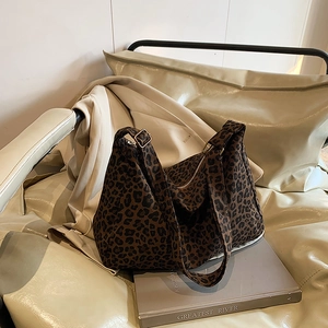 Chic leopard print canvas tote bag for women featuring long shoulder straps and zipper closure