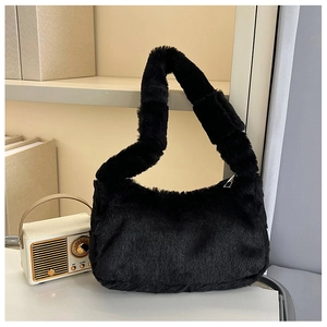 Detail of black faux fur shoulder bag with soft plush texture and smooth zipper closure