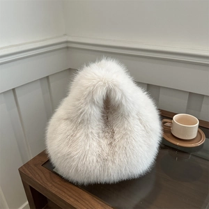 White fluffy faux fur handbag with plush texture and stylish winter minimalist design