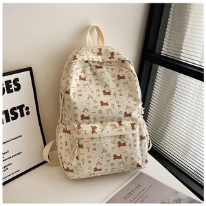 Détail du sac à dos étudiant à fleurs avec motifs de chiots et poches latérales