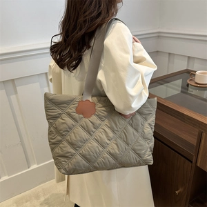 Quilted tote bag with floral accents and large capacity shown in olive green color