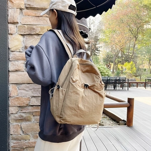Minimalist khaki high-capacity backpack for students with side drawstring and nylon texture