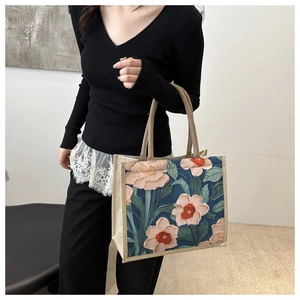 Detailed close-up of a floral canvas tote bag with thick oil-painting brushwork patterns